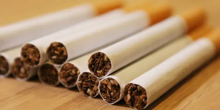 a group of cigarettes sitting on top of a wooden table