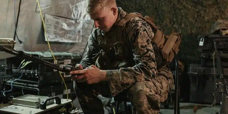 man in brown and black camouflage uniform holding rifle